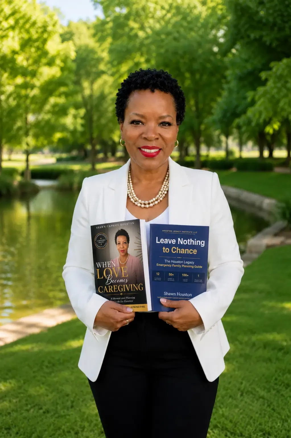Shawn Caprice Houston in a white blazer holding the book covers When Love Becomes Caregiving and Leave Nothing to Chance in a green park